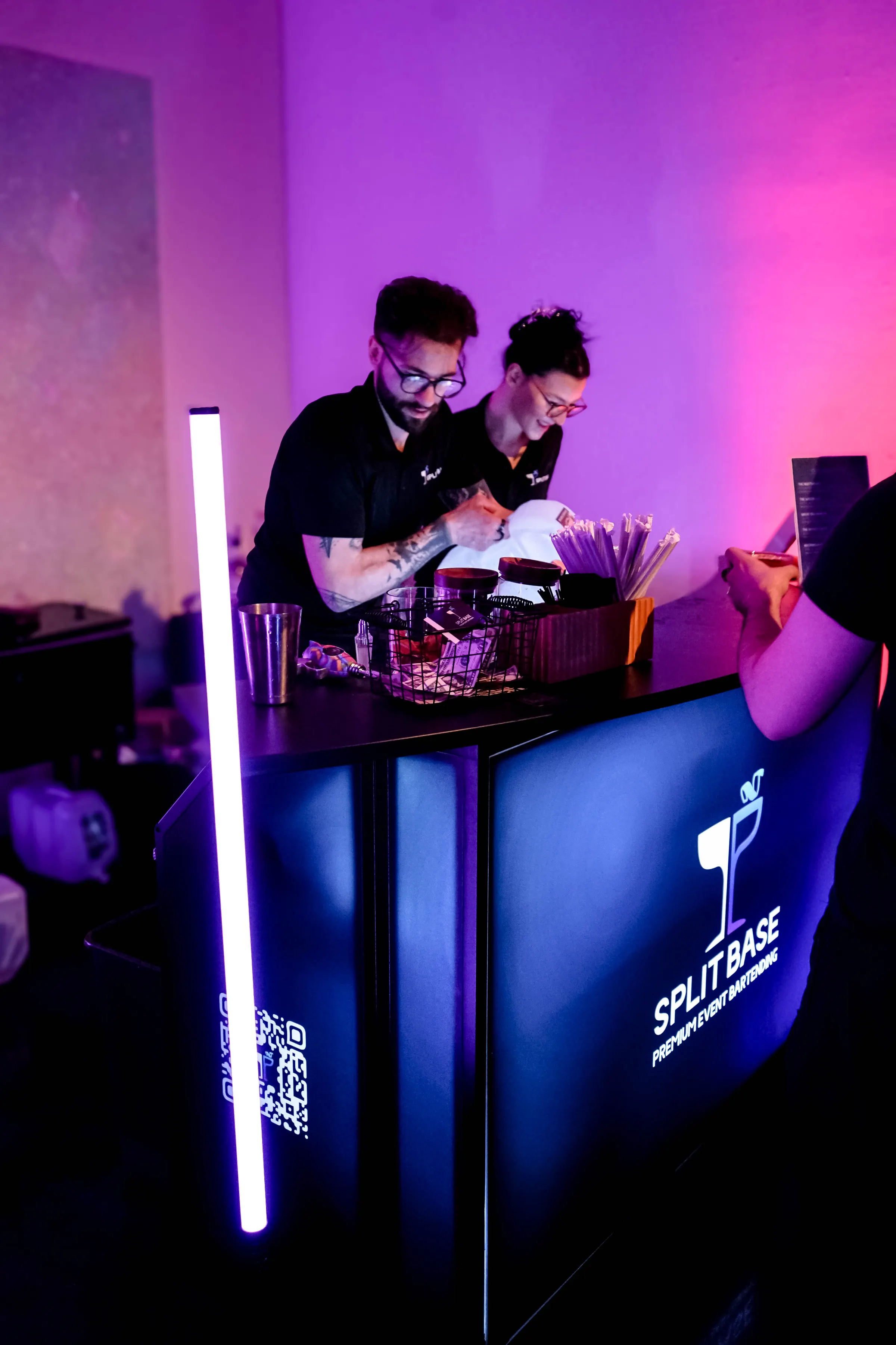 The Split Base team working the glowing branded bar at a showcase event