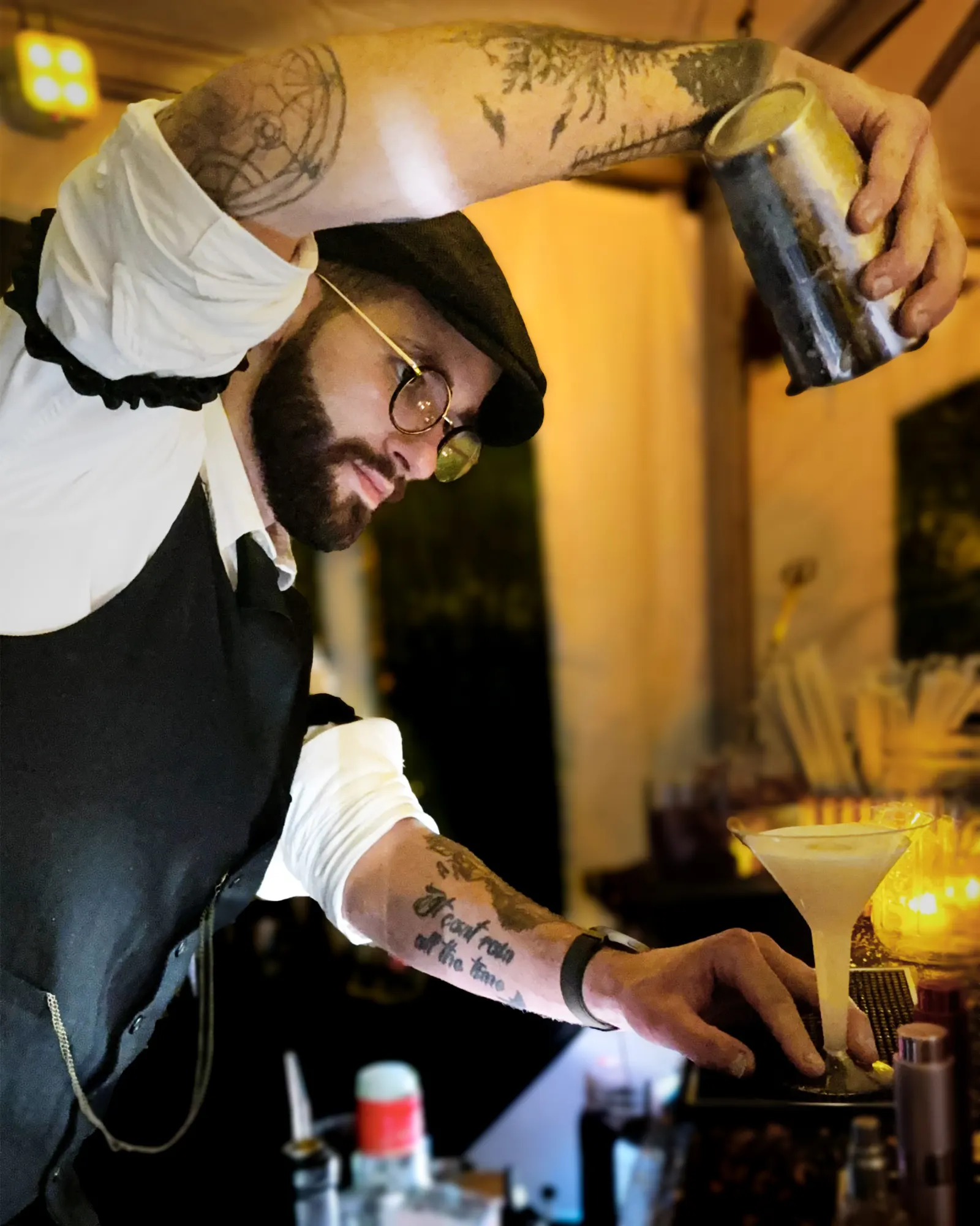 Bartender in period dress straining a cocktail at the Serbian Festival