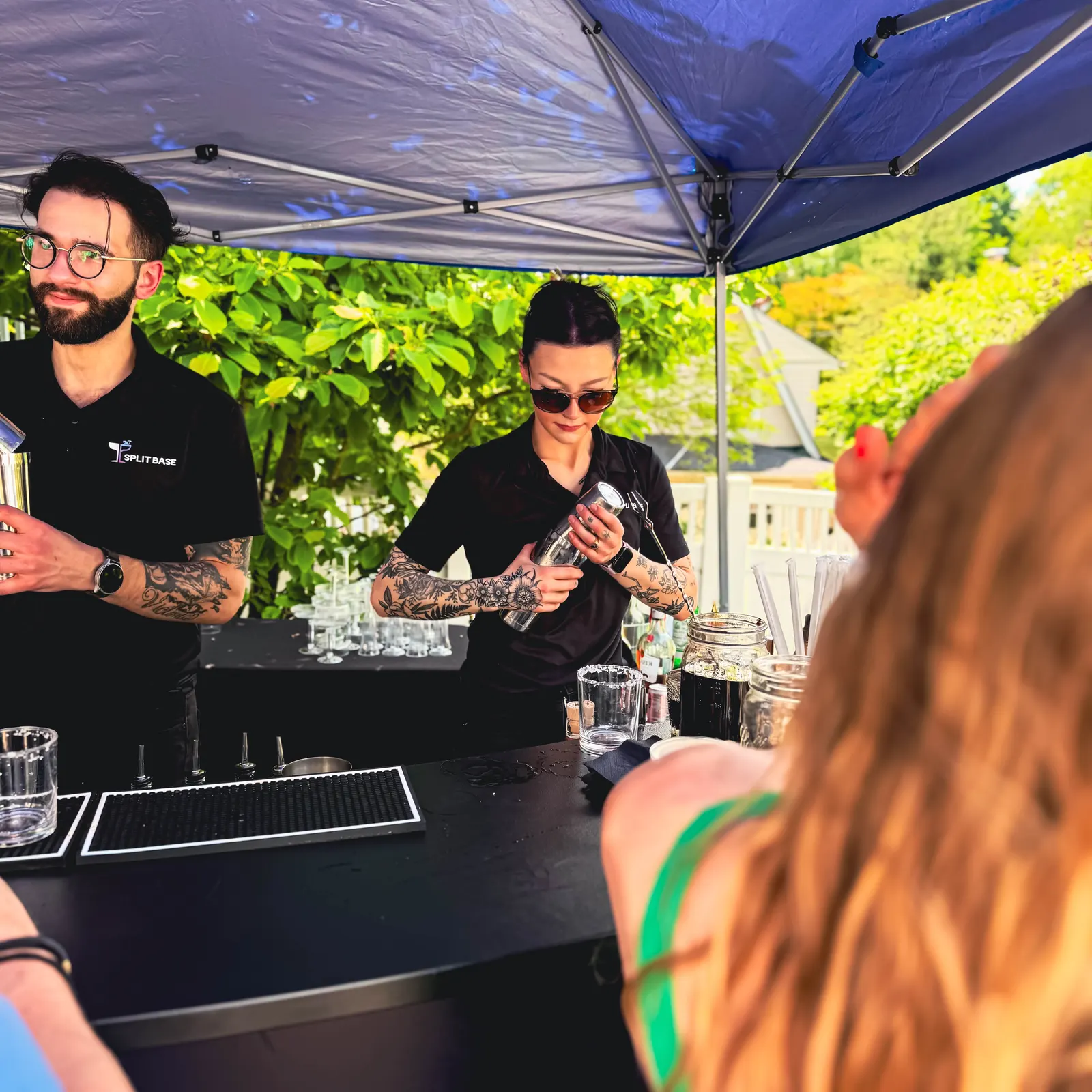 Guests being served drinks across the bar top at the graduation party