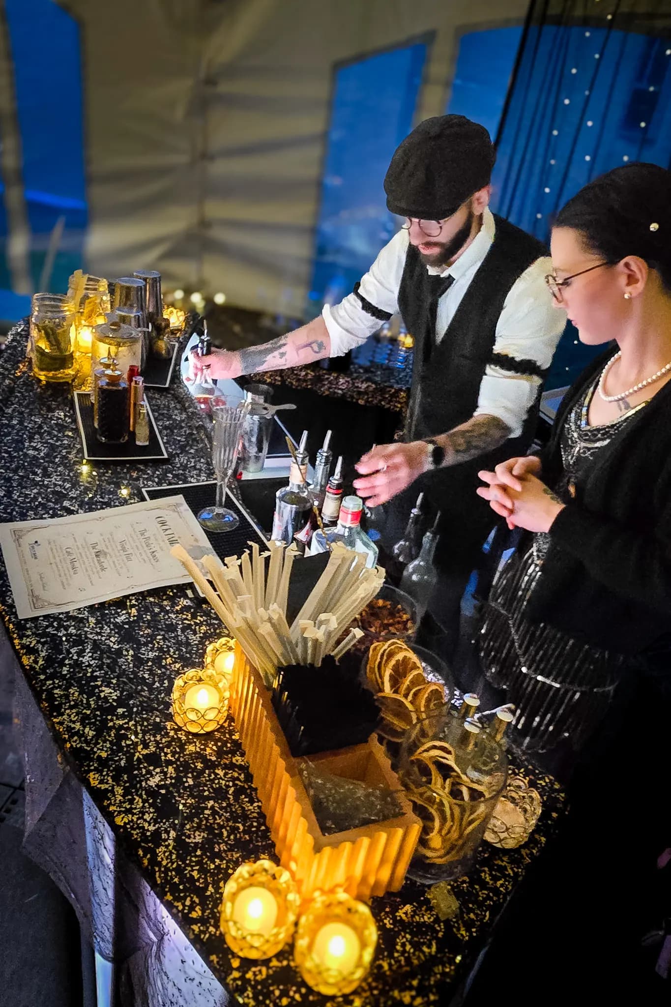 Bar details at the Serbian Festival: glassware, garnish, and tools laid out on a gold sequin bar cloth
